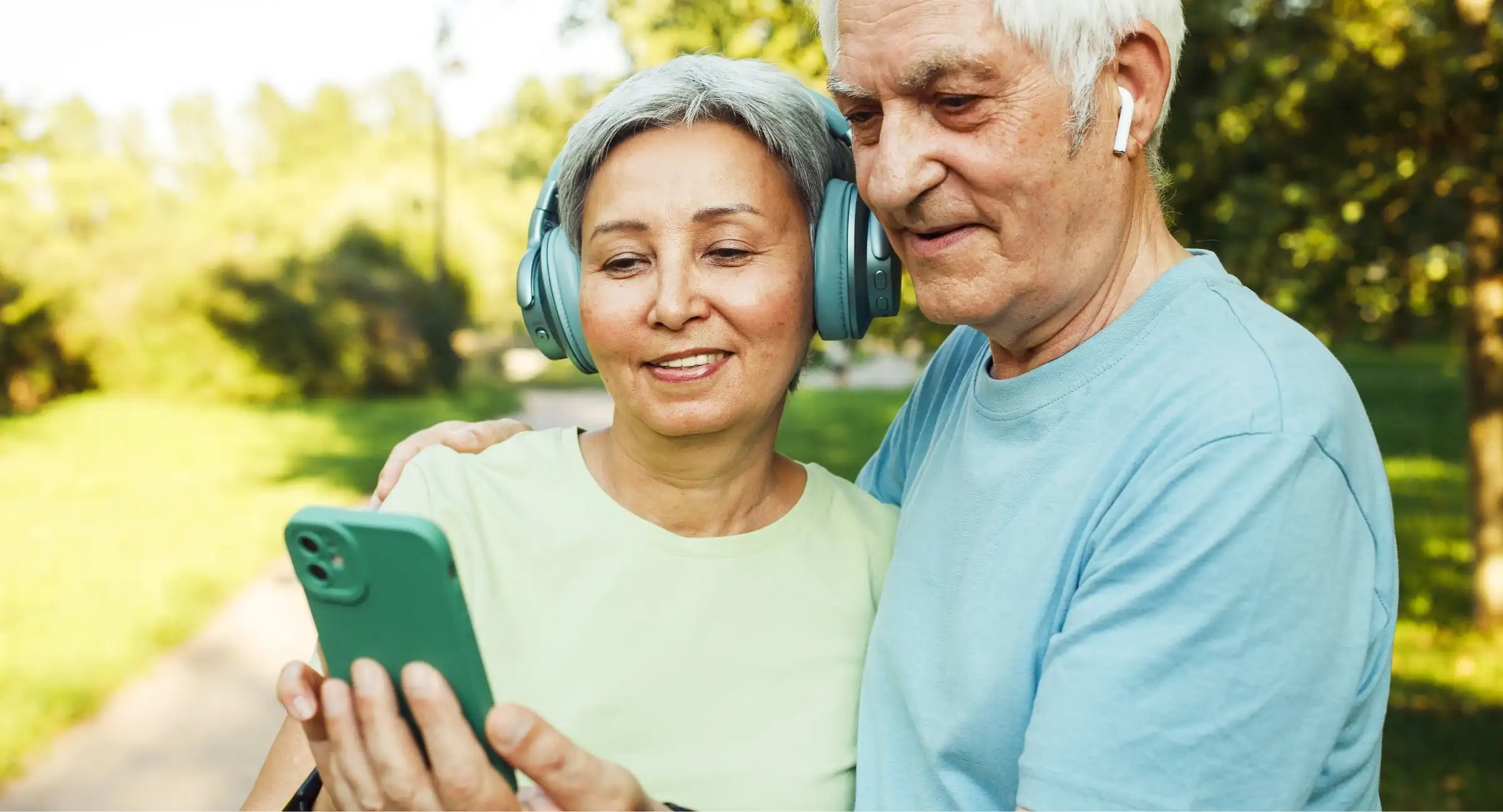 senior couple looking at a phone while outdoors