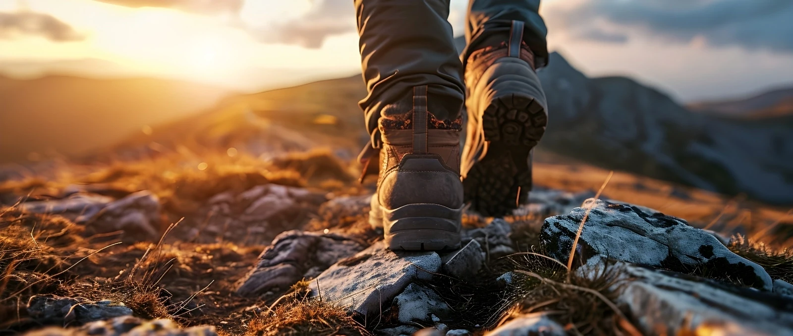 close up of hiker's boots walking on top of mountain