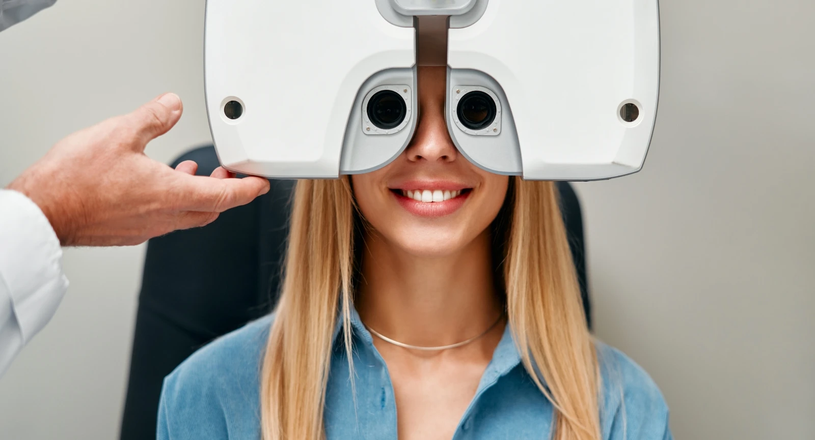 young smiling woman taking an eye exam