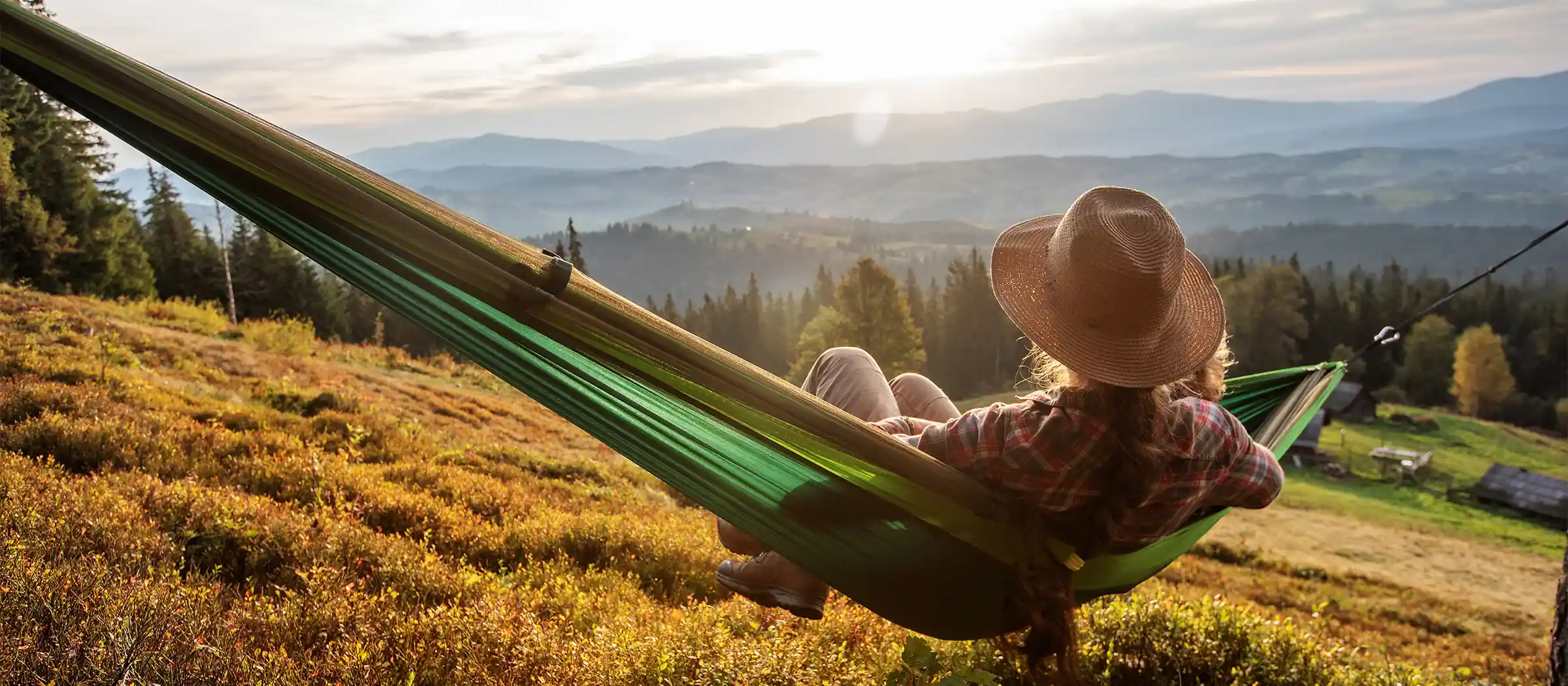 hiker laying in hammock enjoying mountain views