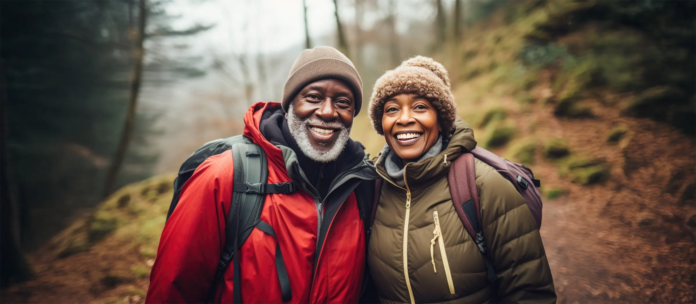 happy senior couple hiking on nature trail
