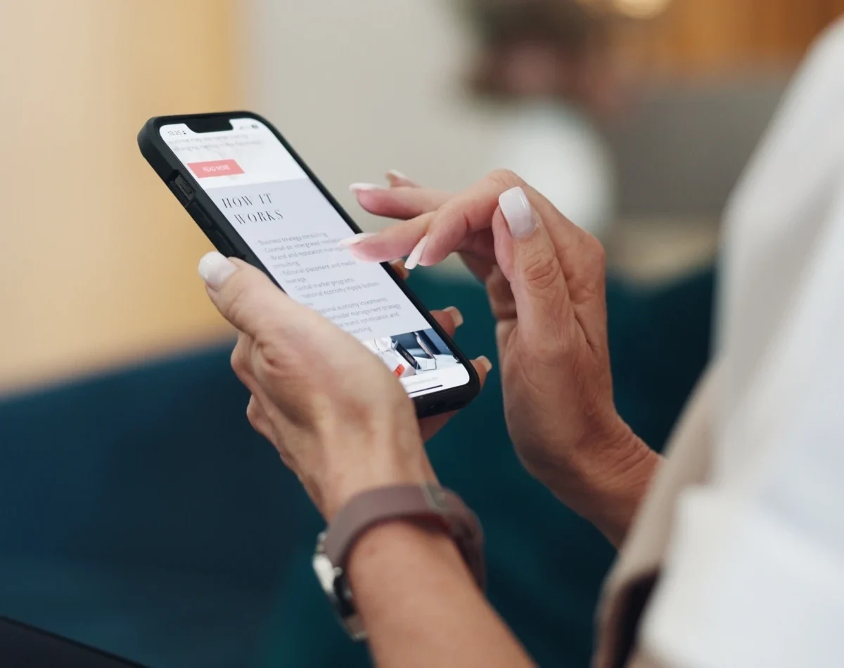 aging woman reading text on her phone