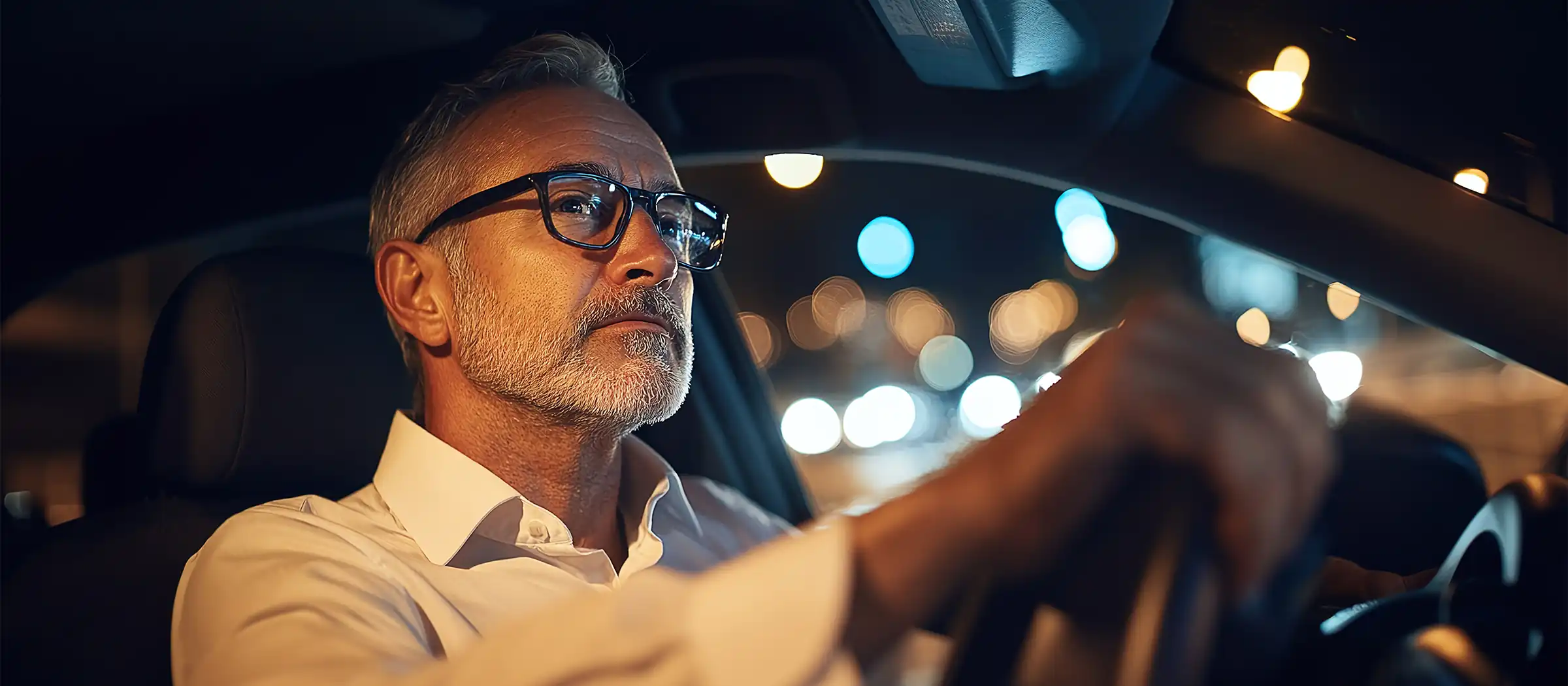 senior man driving at night time