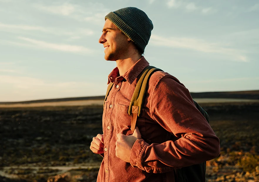 young hiker admiring the sunset